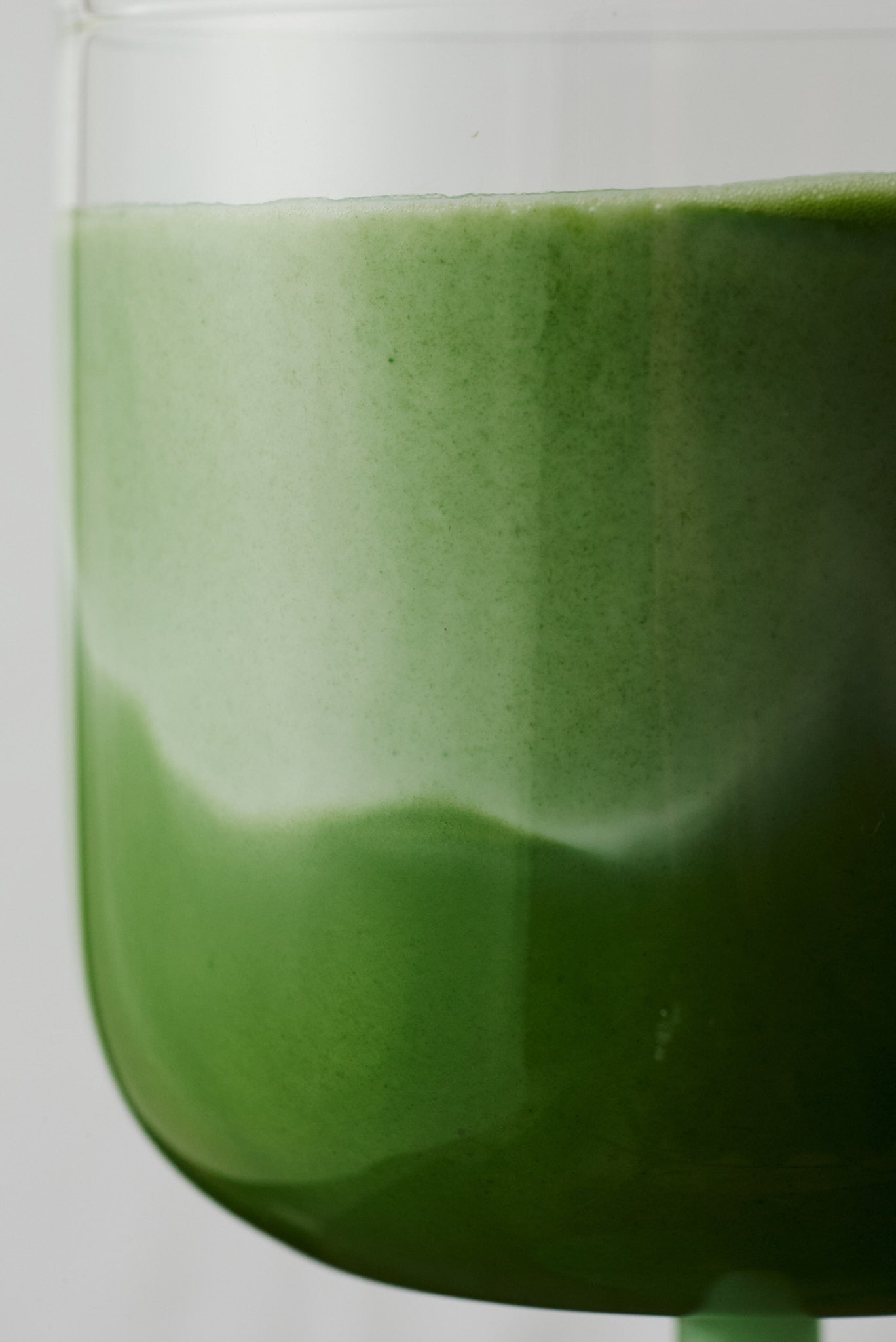 Ceremonial matcha whisked in glass, vibrant green frothy matcha tea from NAKAI 212 blend