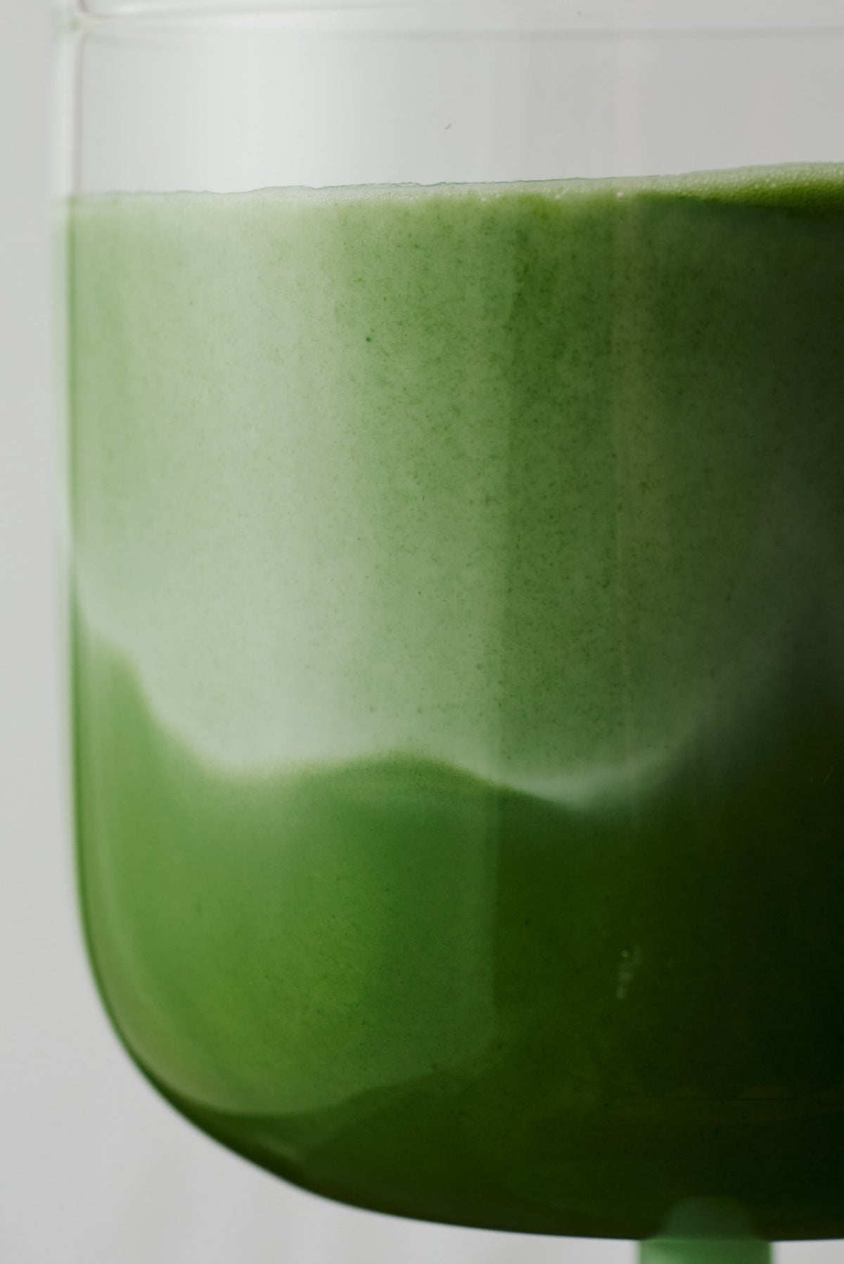 Ceremonial matcha whisked in glass, vibrant green frothy matcha tea from NAKAI 212 blend
